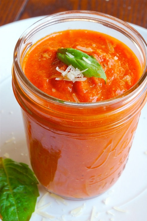 Close up side image of a small mason jar of homemade tomato sauce.