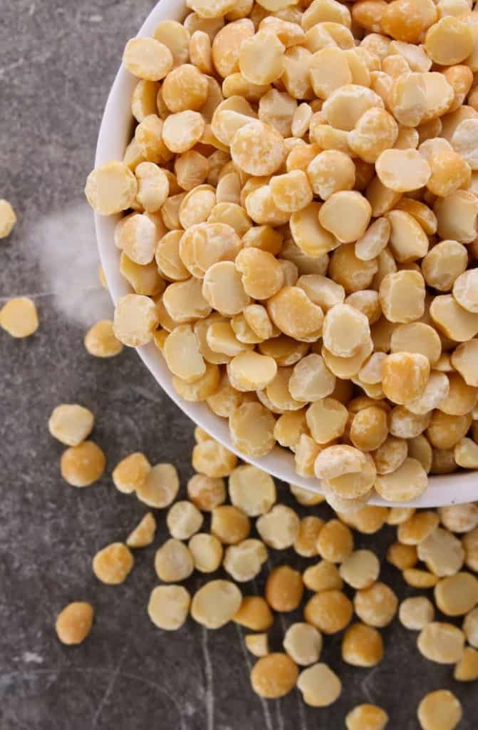 Overhead image of a bowl overflowing with yellow peas, used to make pea protein.
